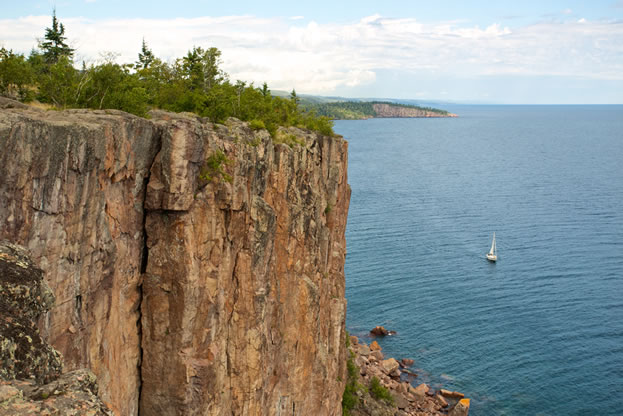 photo of a cliff large body of water below