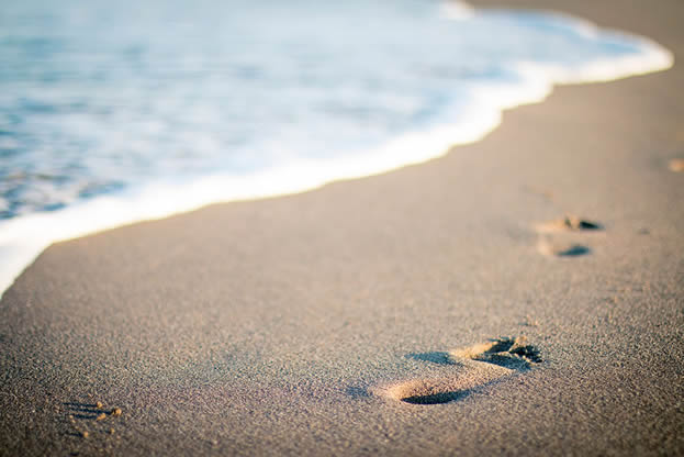 photo of footprints on a beach