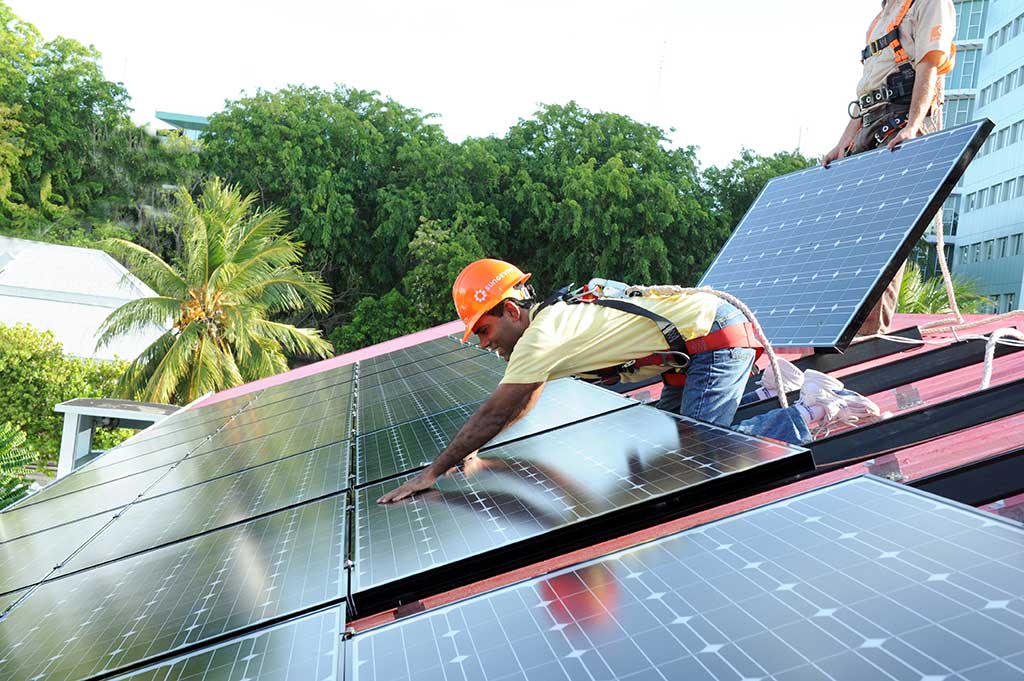 photo of someone installing a solar array