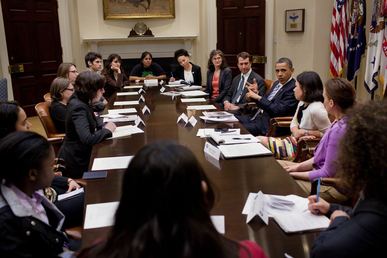 US President Barack Obama with young people at a conference table