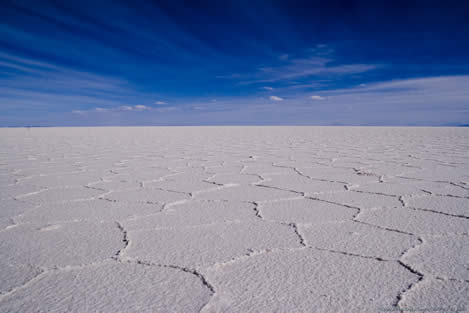 photo of a salt flat under a blue sky
