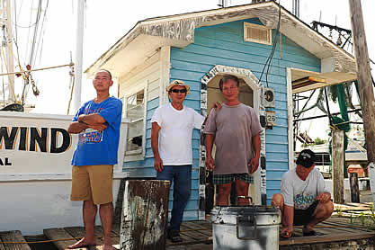 photo of a family on a dock near a fishing boat