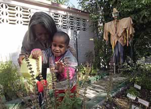 photo of an adult and a child working in a garden
