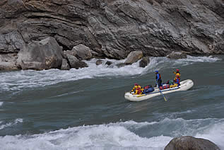 photo of a raft on a swift river