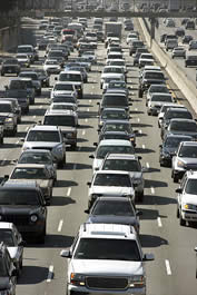photo of cars on a freeway, crowded together