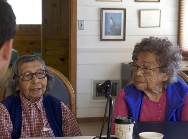 photo of two women elders speaking into a microphone
