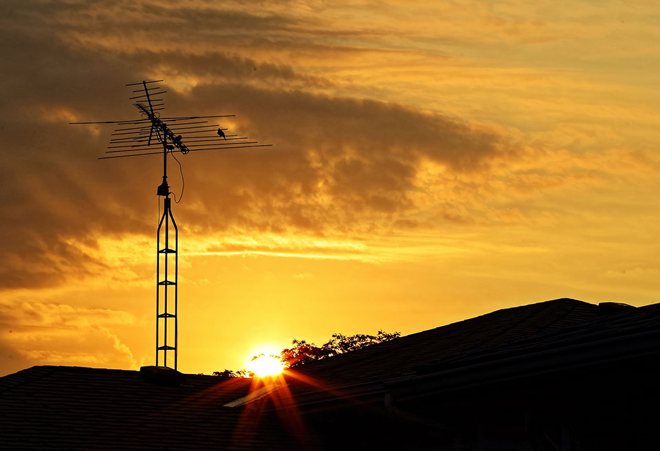 photo of a tv aerial at sunset