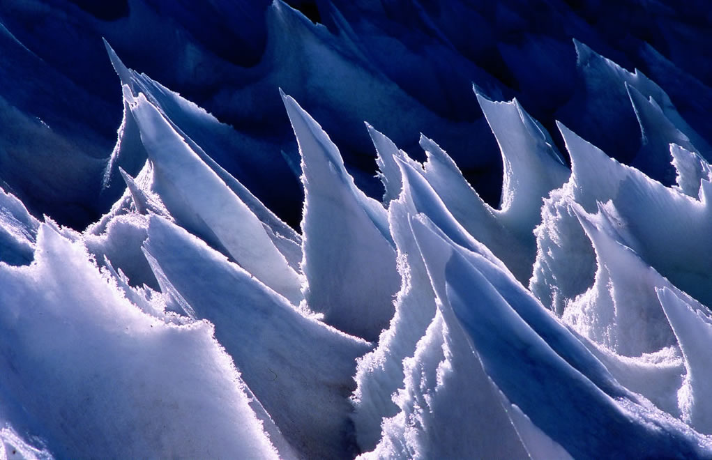detail photo of a dramatic ice-scape; wave-like forms with sharp peaks