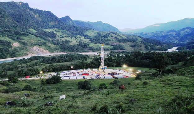 photo of a drilling operation in a tropical clearing