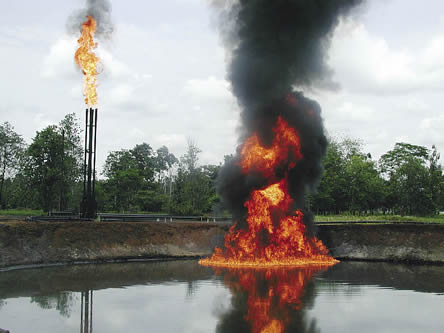 photo of a lake or pond on fire, flaring gas jets in background