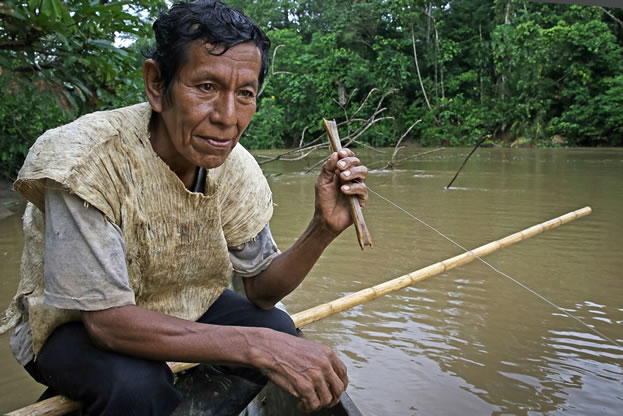 photo of a man, fishing in a tropical river, unhappy
