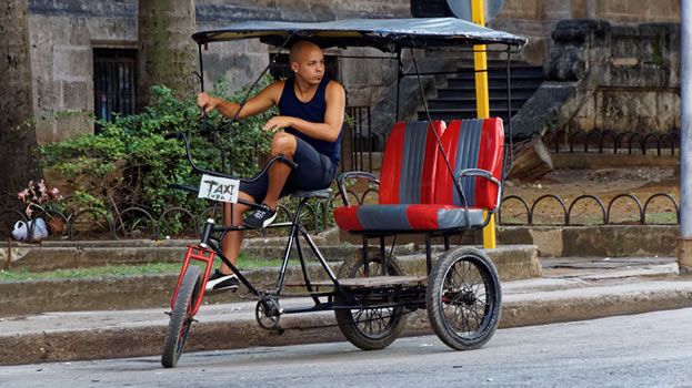 man on a 3-wheeled bike taxi