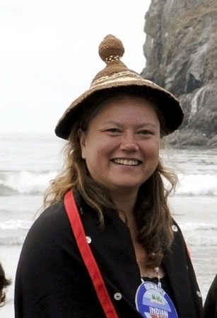 photo of a woman, smiling and wearing a hat
