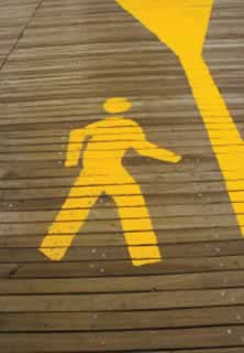 photo of a stylized pedestrian glyph as painted on a walkway