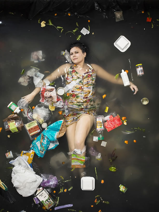 photo of a woman in a murky puddle of trash