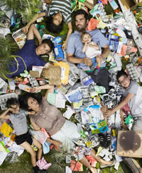 small photo of a large family on a picnic lawn covered in trash