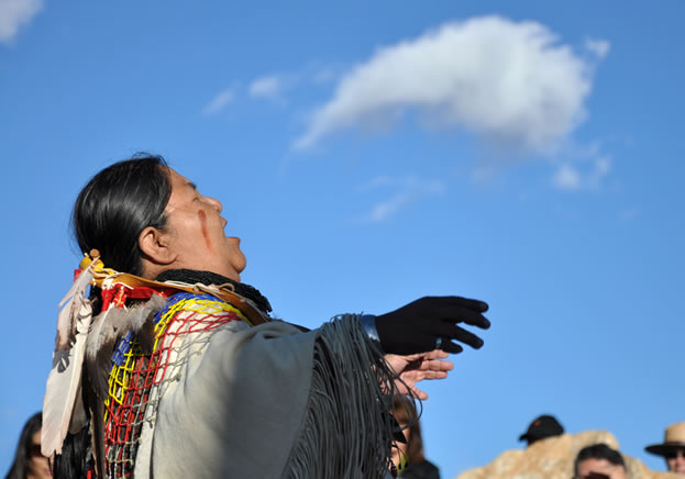 photo of a woman looking skyward and singing
