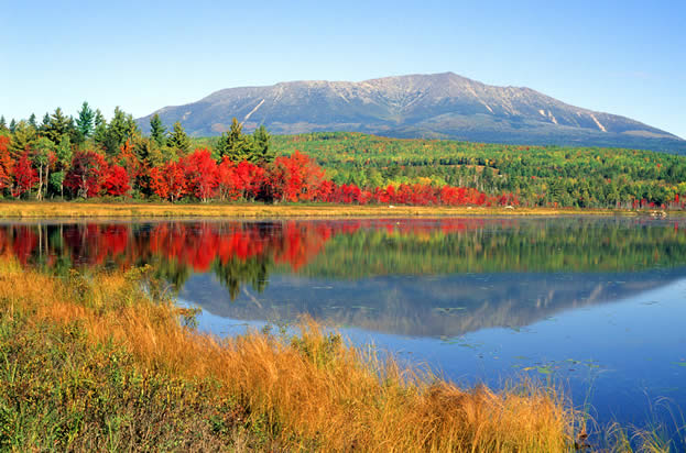 photo of a lake and mountian, forest in full Autumn color in the middle distance