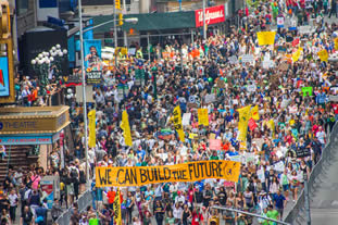 photo of many demonstrators filling a wide avenue