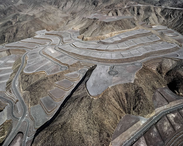 aerial photo of lots carved into a mountainside, devoid of any activity