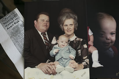 collage showing a newspaper clipping and a family with a baby, the baby has facial deformities