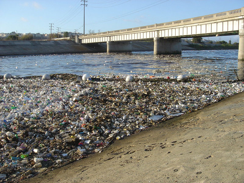 photo of a shoreline buried in plastic waste