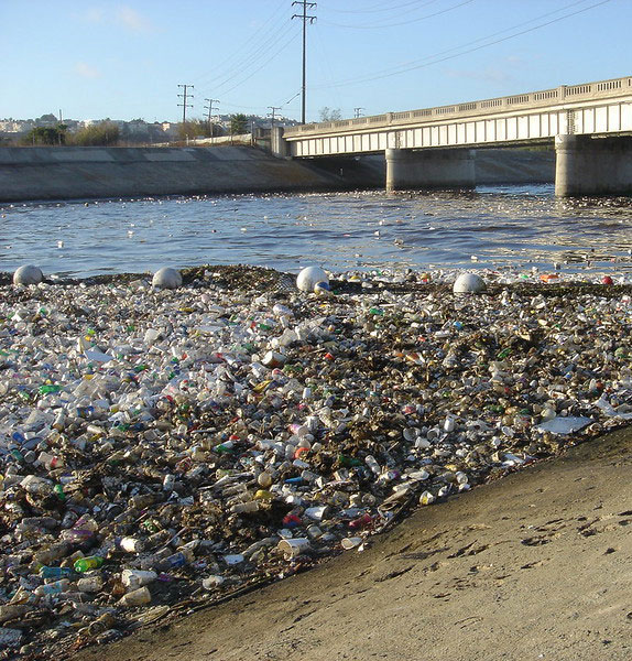 photo of plastic garbage in a watercourse